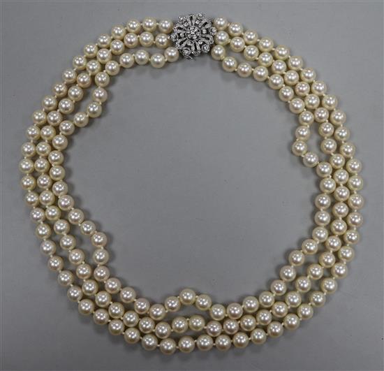 A triple strand cultured pearl necklace with 14ct white gold diamond cluster clasp, approx. 52cm.